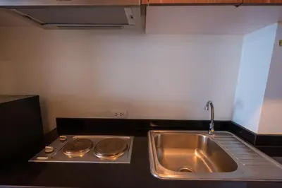 a kitchen with a sink and a stove at Golden Manora Hotel Bangtao Beach Phuket in Bang Tao Beach