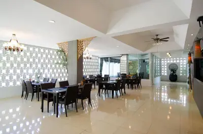 a dining room with tables and chairs and a ceiling at Golden Manora Hotel Bangtao Beach Phuket in Bang Tao Beach