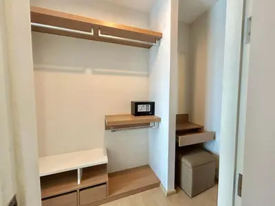 a walk in closet with a clock on a shelf at 2 bedrooms Condos in Bangtao in Bang Tao Beach
