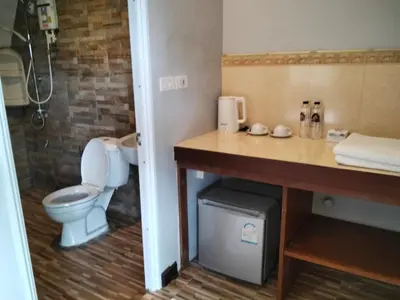 a bathroom with a toilet and a sink at Mountain View Resort in Nai Yang Beach