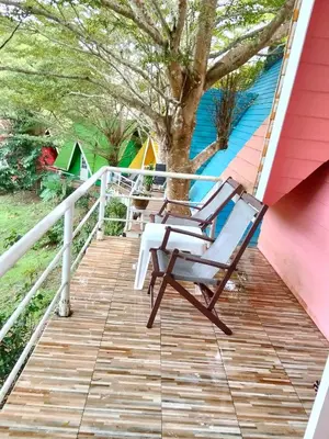 a deck with two chairs and a tree at Mountain View Resort in Nai Yang Beach