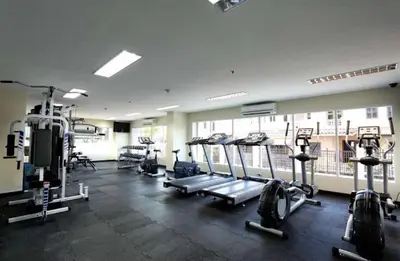 a gym with treadmills and machines in a room at Phuket Villa Patong in Patong Beach