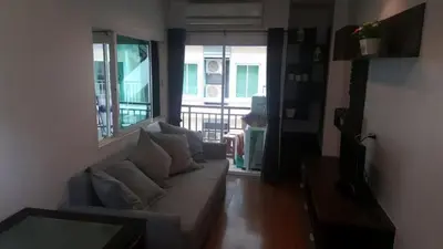 a living room with a couch and a balcony at Phuket Villa Patong in Patong Beach