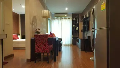 a kitchen with a table and a refrigerator in a room at Phuket Villa Patong in Patong Beach