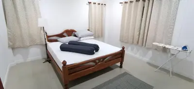 a bed with blue pillows on it in a room at Bassara House 2 bedroom in Koh Lone