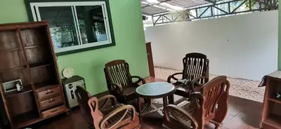 a room with chairs and a table and a mirror at Bassara House 2 bedroom in Koh Lone