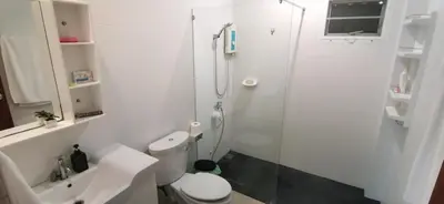 a white bathroom with a shower and a toilet at Bassara House 2 bedroom in Koh Lone