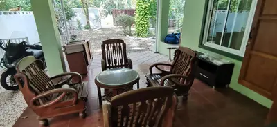 a group of chairs and a table on a porch at Bassara House 2 bedroom in Koh Lone