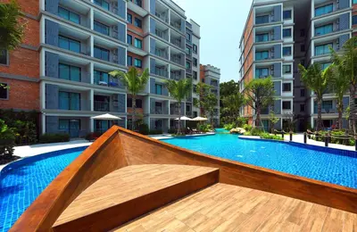 a swimming pool in front of a building at 1 BR apartment in Title Naiyang in Nai Yang Beach