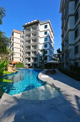 a swimming pool in front of a apartment building at 1 BR apartment in Title Naiyang in Nai Yang Beach