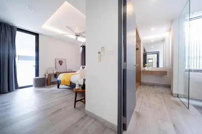 a bedroom with a bed and a sliding glass door at \u666e\u5409\u5c9b\u6700\u8457\u540d\u7684Laguna\u62c9\u53e4\u5a1c \u4e94\u5367\u5ba4\u79c1\u4eba\u6cf3\u6c60\u522b\u5885 \u5bbd\u655e\u8212\u9002 in Phuket Town