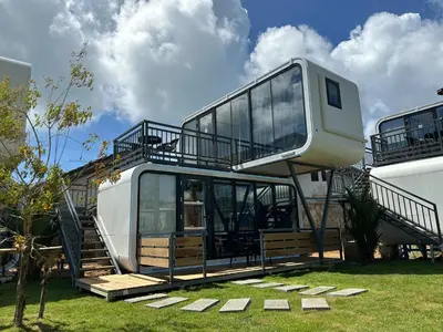 a house with a balcony on the side of it at Space House Hotel Phuket in Rawai Beach