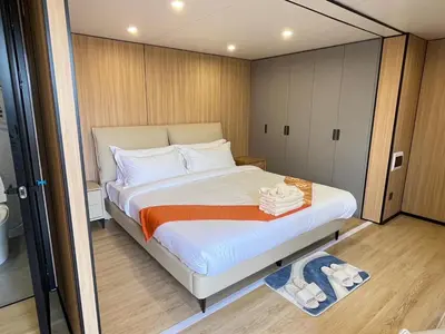 a bedroom with a large bed in a room at Space House Hotel Phuket in Rawai Beach