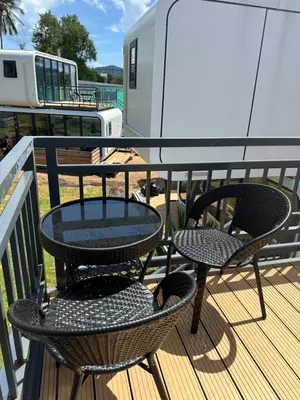 two chairs and a table on a deck at Space House Hotel Phuket in Rawai Beach