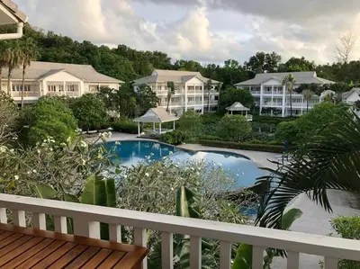 a view of a pool from the balcony of a resort at Ocean breeze studio 1 bed in Ban Pak Lak