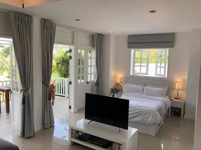 a bedroom with a bed and a tv on a table at Ocean breeze studio 1 bed in Ban Pak Lak