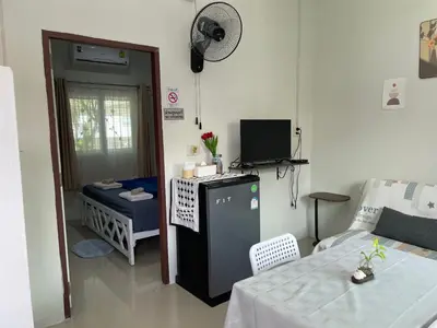 a room with a room with a table and a television at Yada House s&h in Nai Yang Beach