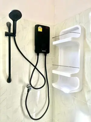 a bathroom with a soap dispenser on a wall at Yada House s&h in Nai Yang Beach