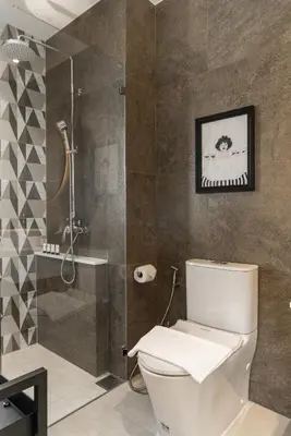 a bathroom with a toilet and a shower at Title Halo Memories Naiyang Pool Gym Sauna in Nai Yang Beach