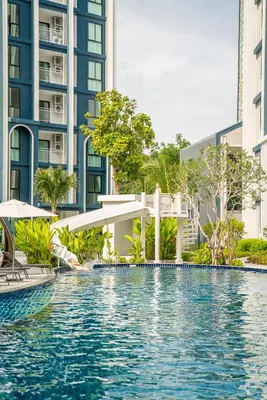 a swimming pool in the middle of a building at Title Halo Memories Naiyang Pool Gym Sauna in Nai Yang Beach