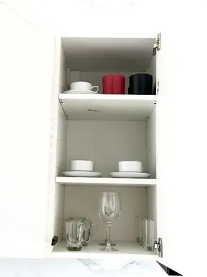 a white cabinet with a wine glass in it at Apartment Karon SeaView 72 sq in Karon Beach