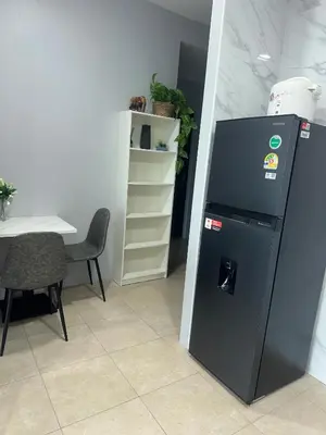 a refrigerator in a room with a table and a chair at Apartment Karon SeaView 72 sq in Karon Beach