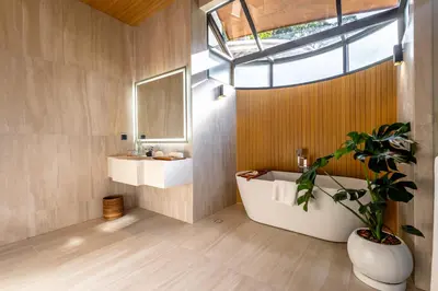 a bathroom with a tub and a sink and a plant at Sinae Residence in Ban Lo Ti Pa (1)
