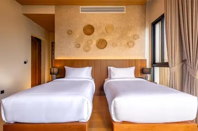 two beds sitting next to each other in a room at Sinae Residence in Ban Lo Ti Pa (1)