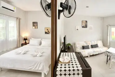 a bedroom with a bed and a living room at Yada House s&s in Nai Yang Beach