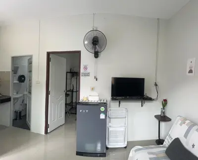 a living room with a tv and a couch at Yada House s&s in Nai Yang Beach