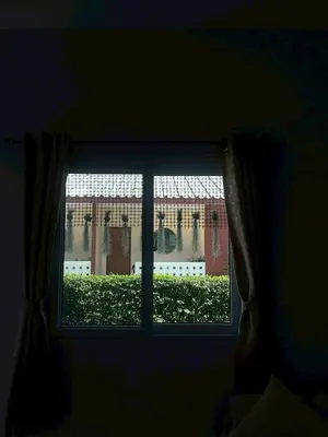 a window in a dark room with a view at Yada House s&s in Nai Yang Beach