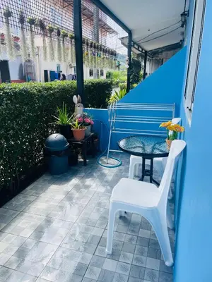 a patio with a blue bench and a table at Yada House s&s in Nai Yang Beach