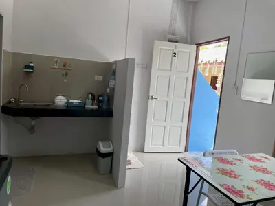 a bathroom with a sink and a door and a table at Yada House s&s in Nai Yang Beach