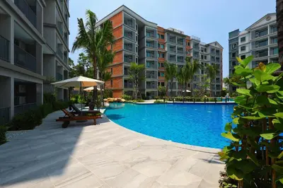 a swimming pool in the middle of some apartment buildings at 300 m to Naiyang Beach by Capital Pro in Nai Yang Beach