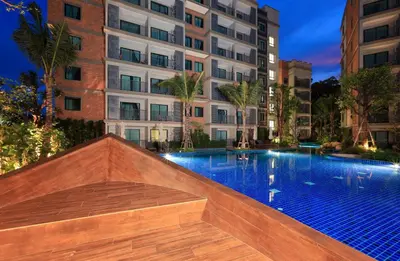 a swimming pool in front of a building at 300 m to Naiyang Beach by Capital Pro in Nai Yang Beach