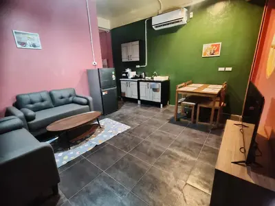 a living room with a couch and a table at Bonanza Patong Beach2 for 2 BR 100m to Beach Grace Room in Patong Beach