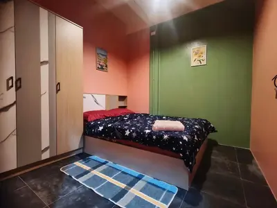 a small bedroom with a bed in a green room at Bonanza Patong Beach2 for 2 BR 100m to Beach Grace Room in Patong Beach