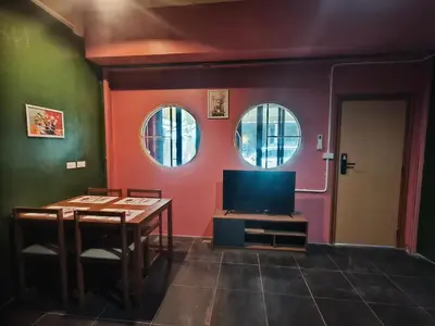 a living room with a table and a tv at Bonanza Patong Beach2 for 2 BR 100m to Beach Grace Room in Patong Beach