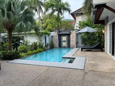 a swimming pool in front of a house at 15 Minuets Walk 2 BangTao Beach Fully Loaded v134 in Bang Tao Beach