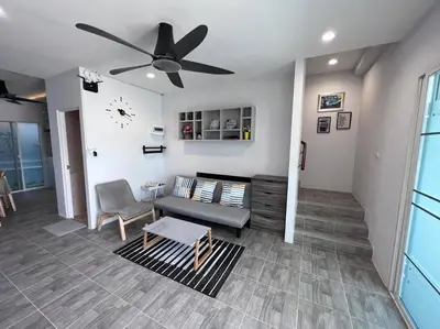a living room with a couch and a ceiling fan at Bang Tao Town House 1km Surin Beach V135 in Thalang