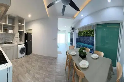a kitchen and dining room with a table and chairs at Bang Tao Town House 1km Surin Beach V135 in Thalang