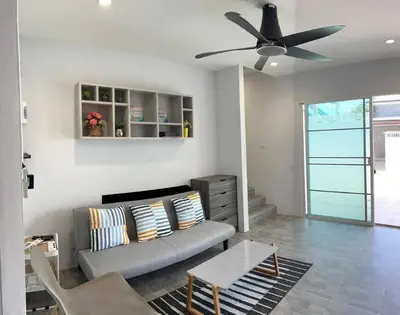 a living room with a couch and a ceiling fan at Bang Tao Town House 1km Surin Beach V135 in Thalang