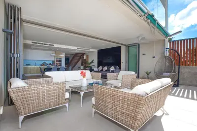 a patio with wicker chairs and a table at Sea View 3BR Duplex in The Sapphire Bay 88 Residence near Patong and Paradise Beach in Patong Beach