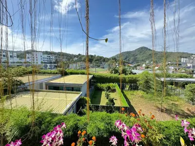 a view of a garden with flowers at Mood Resotel Kamala in Kamala Beach