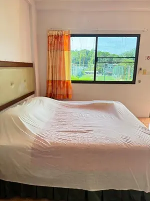 a bed in a room with a window at Mood Resotel Kamala in Kamala Beach