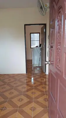 a room with a wooden floor and a door at Mood Resotel Kamala in Kamala Beach