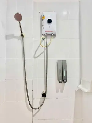 a shower in a bathroom with a camera on the wall at Mood Resotel Kamala in Kamala Beach