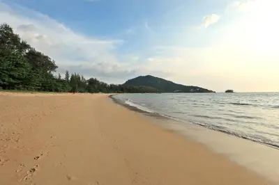 a beach with footprints in the sand next to the water at Apart Pool Access Naiyang Beach in Nai Yang Beach