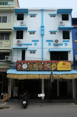 a blue building with a sign in front of it at Burning Flame Patong in Patong Beach