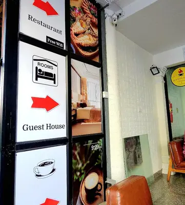 a guest house sign in a room with a guest house at Burning Flame Patong in Patong Beach